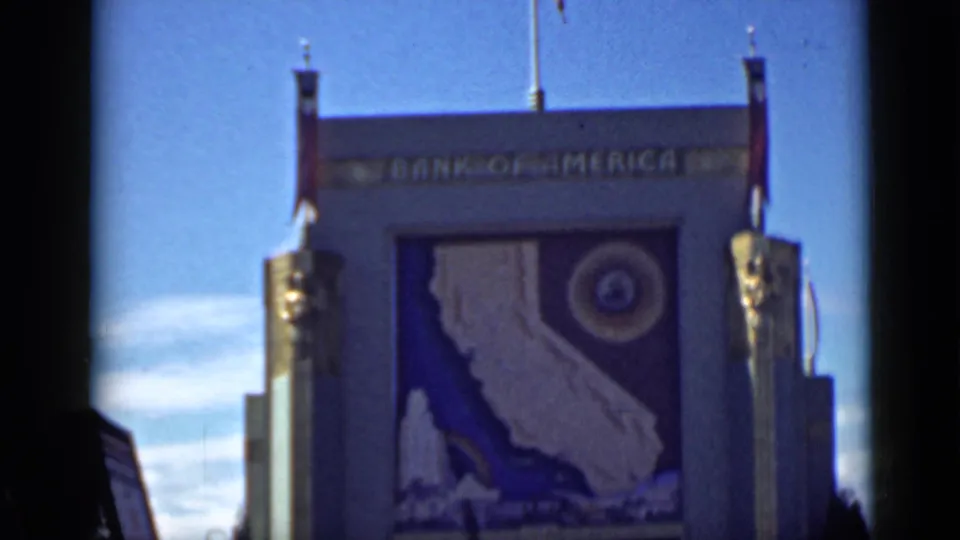 Wide view of the Bank of America pavilion facade at the San Francisco exposition, with the California mural centered below the sign.