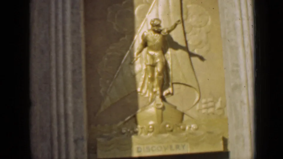 1939 San Francisco frame showing the relief's figure, ship base, and clearer DISCOVERY inscription in warm 8mm color.