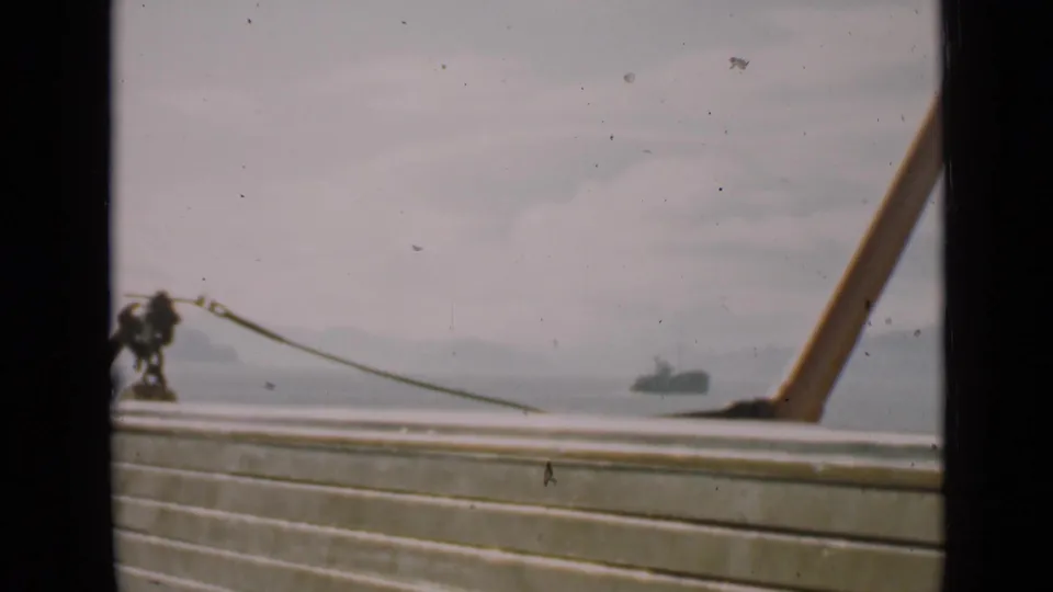 San Francisco harbor view from 1939 home-movie footage, with deck rail, rope hardware, distant hills, and an offshore vessel.