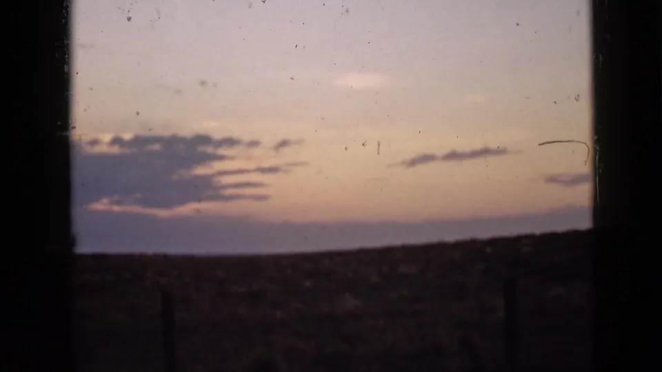 Final 1939 Utah sunset frame shows scattered clouds, a pink-purple sky, and a dark open horizon with visible 8mm grain and specks.
