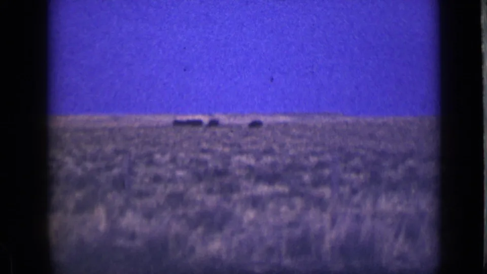 1939 Utah landscape frame with deep blue-purple color, a low rural horizon, and faint distant shapes on the plain.