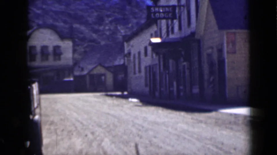 1939 Utah 8mm street view showing lodge-like buildings along a dusty road, including a visible Shrine Lodge sign.