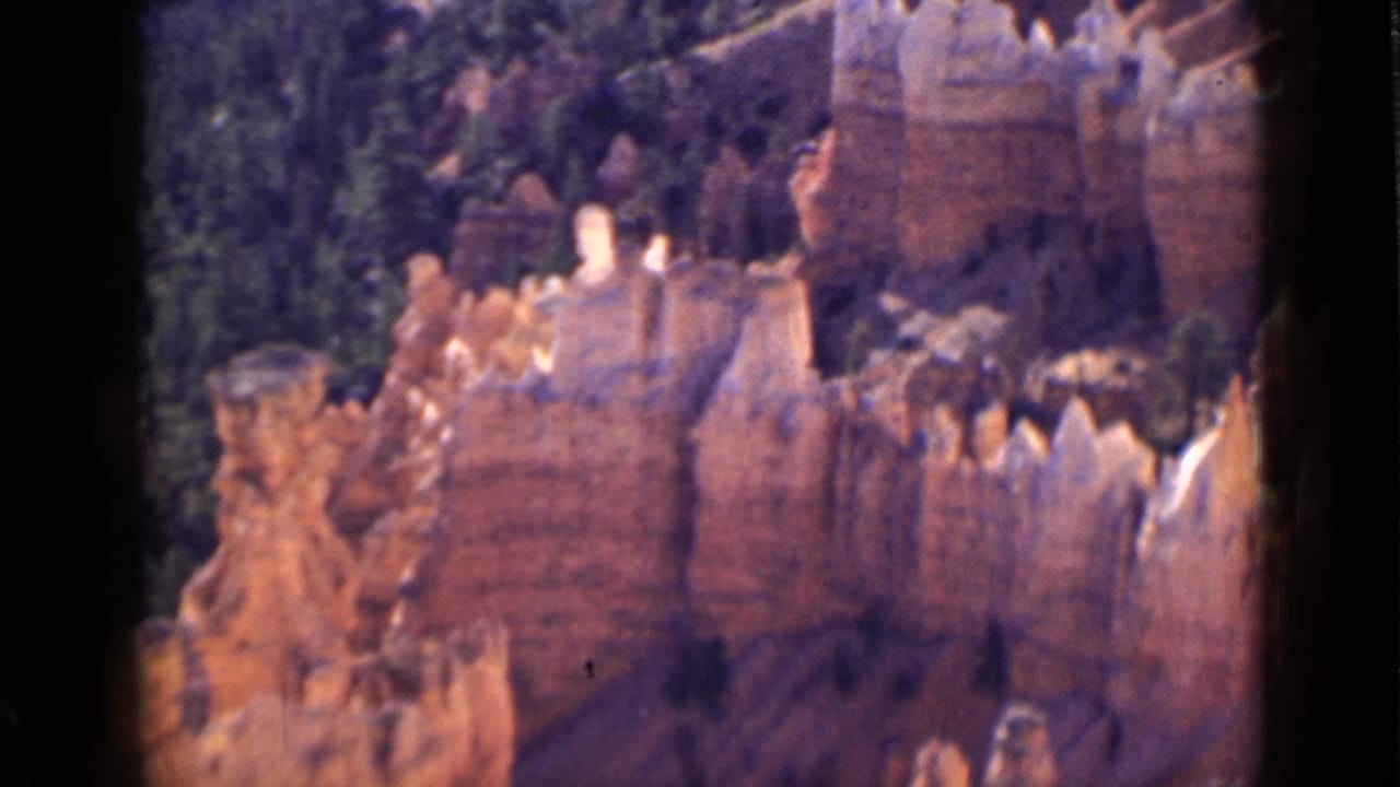 Utah canyon hoodoos and evergreen trees appear in a soft 8mm landscape view, consistent with the clip’s Bryce Canyon metadata.