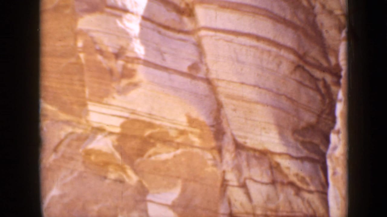1939 Utah 8mm close-up of smooth layered sandstone strata in warm light.