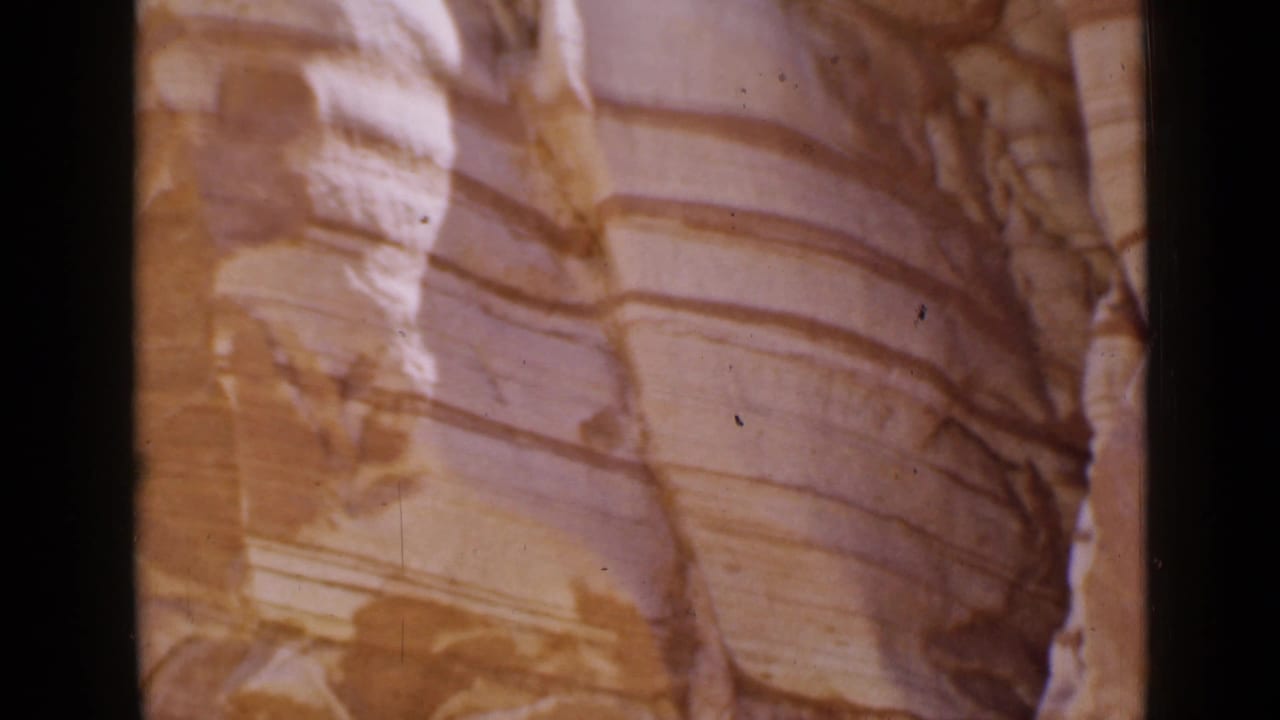 1939 Utah 8mm frame showing striated rock formations beside the road, with warm film color and soft handheld framing.