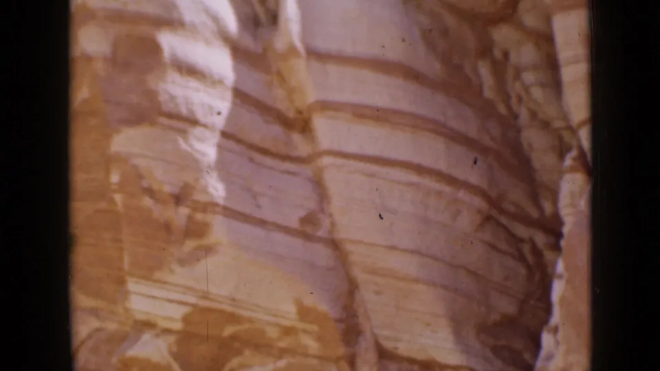 1939 Utah 8mm frame showing striated rock formations beside the road, with warm film color and soft handheld framing.