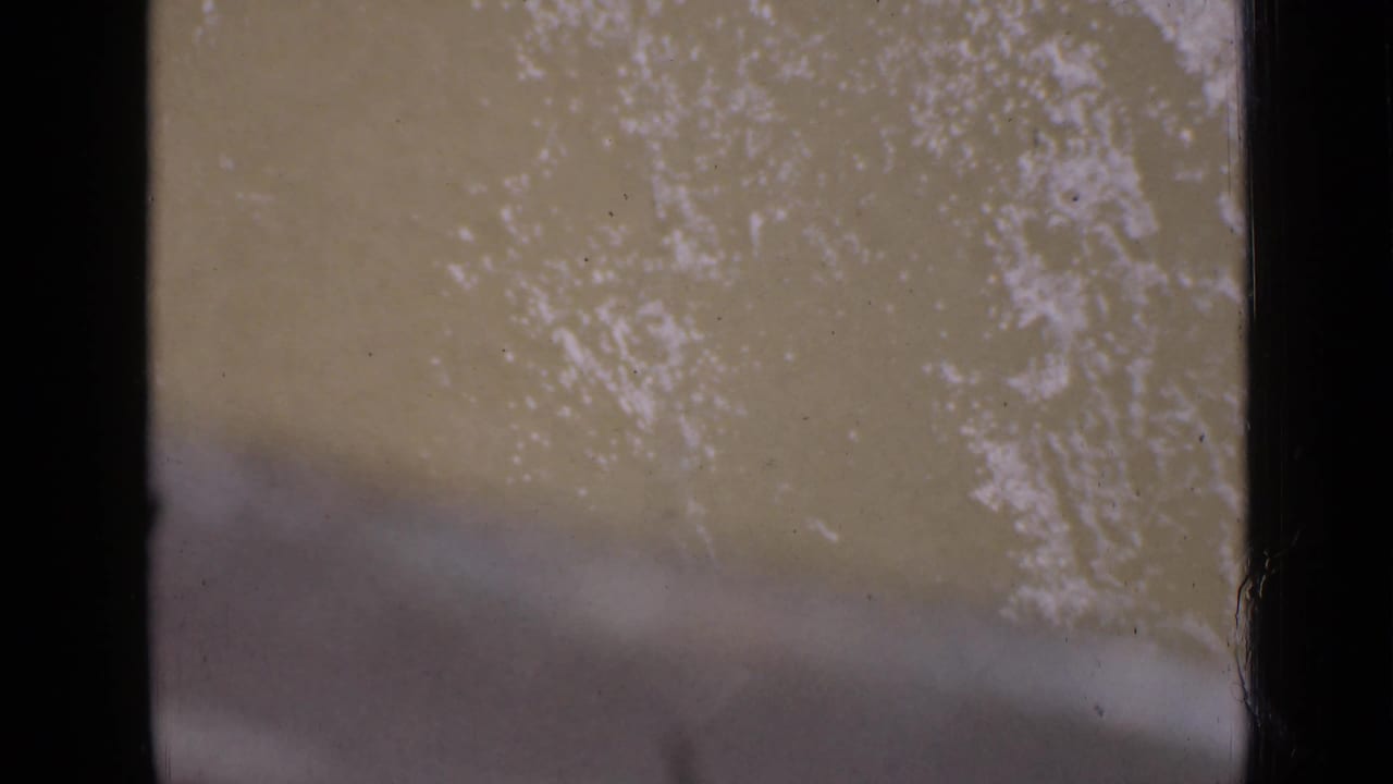 1939 Utah 8mm frame showing a close, soft-focused view of muddy river water within dark home-movie borders.