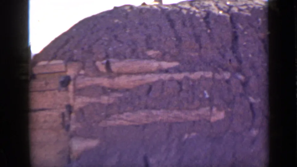 A closer 1939 Utah view shows rough earthen wall surfaces, horizontal timbers, and a dark opening in the structure.