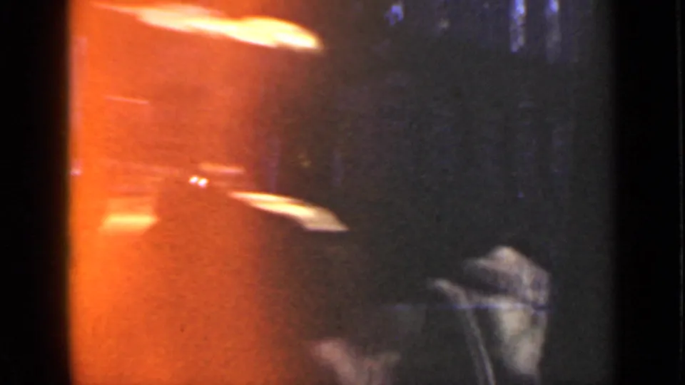 The final 1940 Ontario frame shows a dim window reflection, orange exposure flare, and a partial uniformed figure.