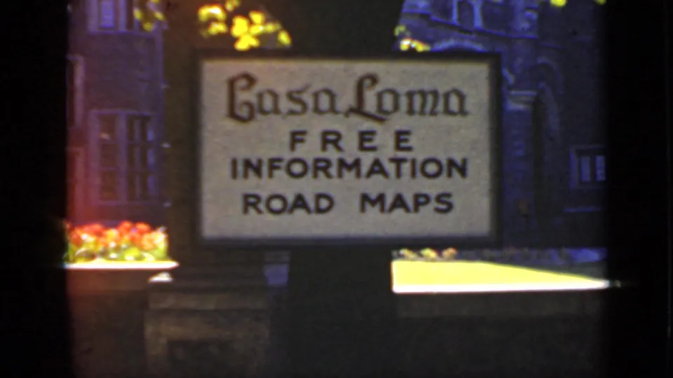Casa Loma information sign in 1940 Ontario footage, with road maps wording, flowers, and dim architectural details around it.