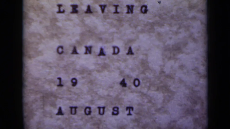 Close 8mm view of the same "LEAVING CANADA 1940 AUGUST" title card, with visible paper grain and soft focus.