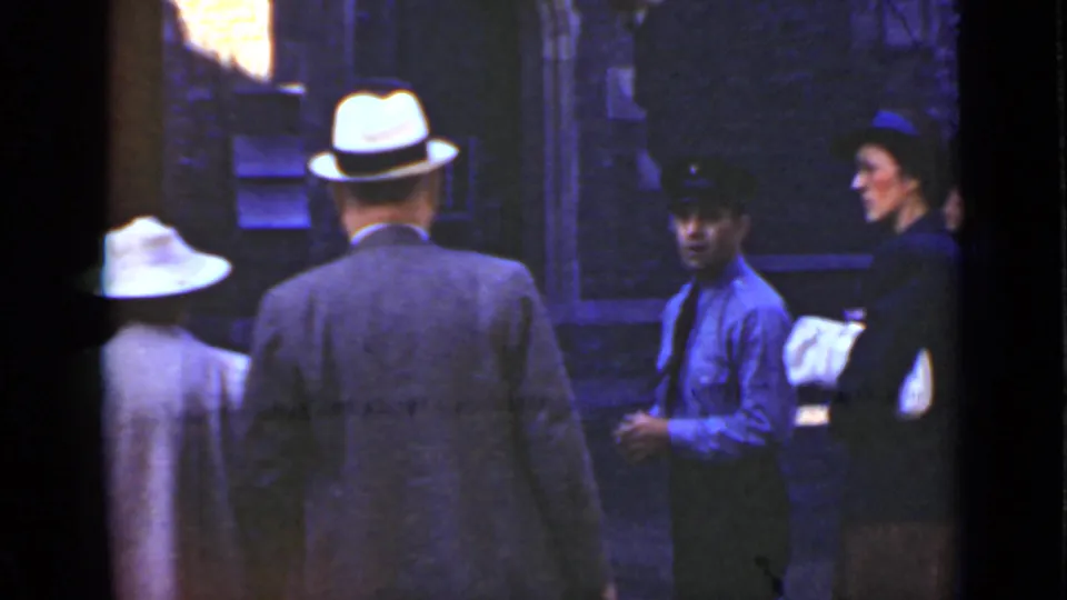 1940 Ontario dock scene with adults in fedoras and a uniformed worker standing near the waterfront.