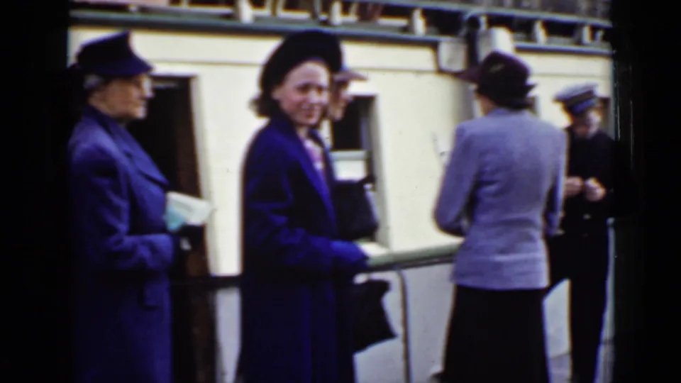 Women in mid-century dress and uniformed crew are visible beside the Dalhousie City as passengers gather at the dock.