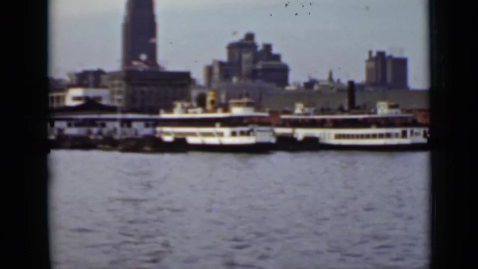 1940 Ontario waterfront view with white passenger ferries, calm water, and a soft city skyline in the background.