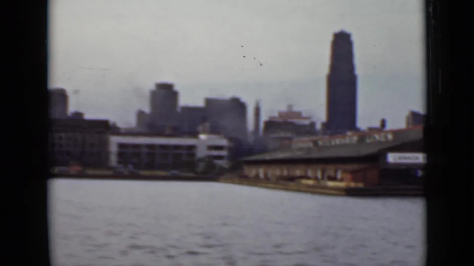 1940 Ontario water-level view of downtown buildings and a wharf with partial Canada Steamship Lines signage visible at right.