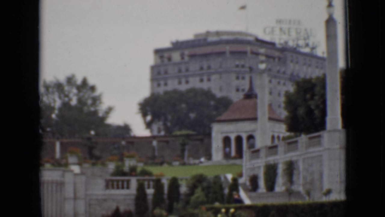 Hotel General Brock seen beyond landscaped grounds and stone terraces.
