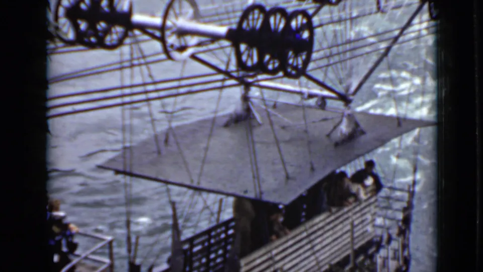 A high-angle 1940s Ontario view shows water, railings, cables, and wheel assemblies over a platform-like structure.