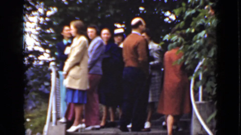 Adults in 1940s-style clothing gather on an Ontario overlook deck, with trees and railings framing the scene.
