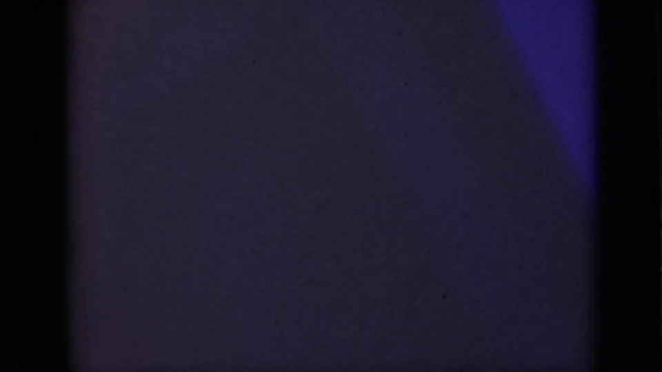 Final 1940 Ontario 8mm frame fading toward darkness, with only purple window light and interior shadow remaining.
