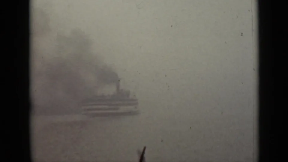Fog-obscured small passenger vessel on an Ontario waterway in 1940, seen in soft 8mm focus.