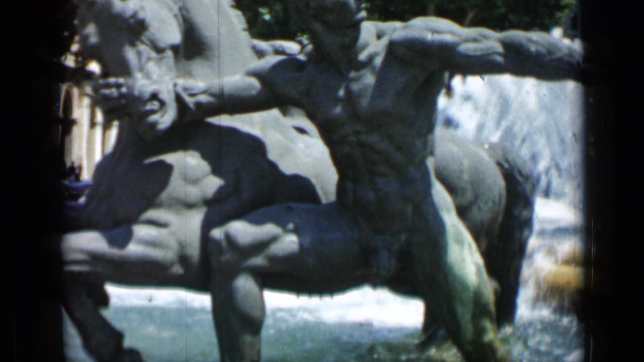 Bronze fountain sculptures with a nude male figure beside spraying water.