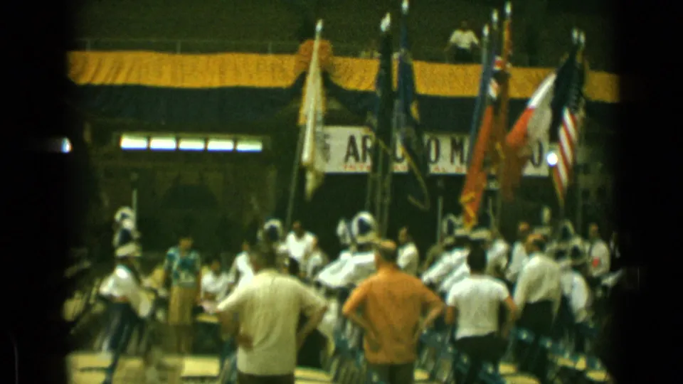 1962 Cannes frame showing a crowded indoor assembly with flags in front, chairs below, and the Arturo Mariano banner partly visible.