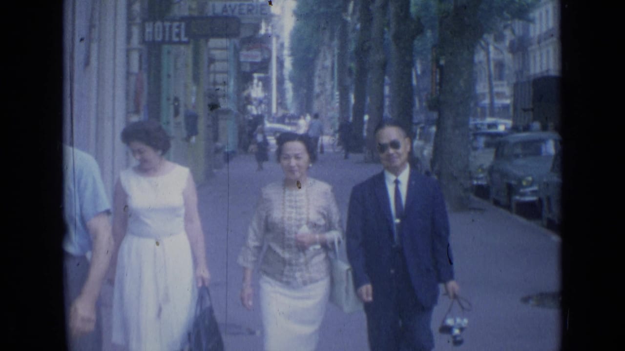 The group draws closer on a Cannes sidewalk, with the man in sunglasses and the women in light 1960s clothing.