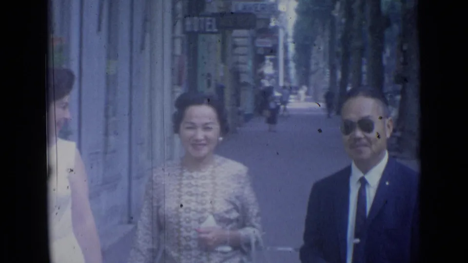At the end of the Cannes street shot, the group passes near the lens, leaving faces, clothing, and sidewalk details prominent.