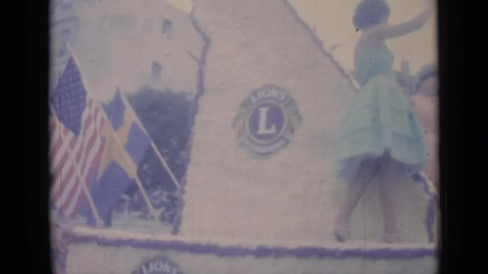 American and Swedish flags are visible beside a Lions Club emblem on the decorated 1962 Cannes parade float.