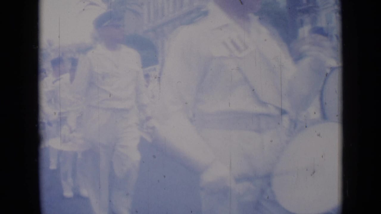 Close view of a band member and large brass instrument during the parade.