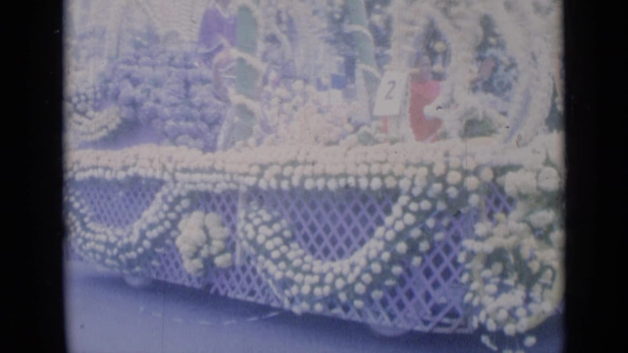 Cannes parade float in 1962 with white floral swags, greenery, lattice framework, and a number 2 placard on the upper section.
