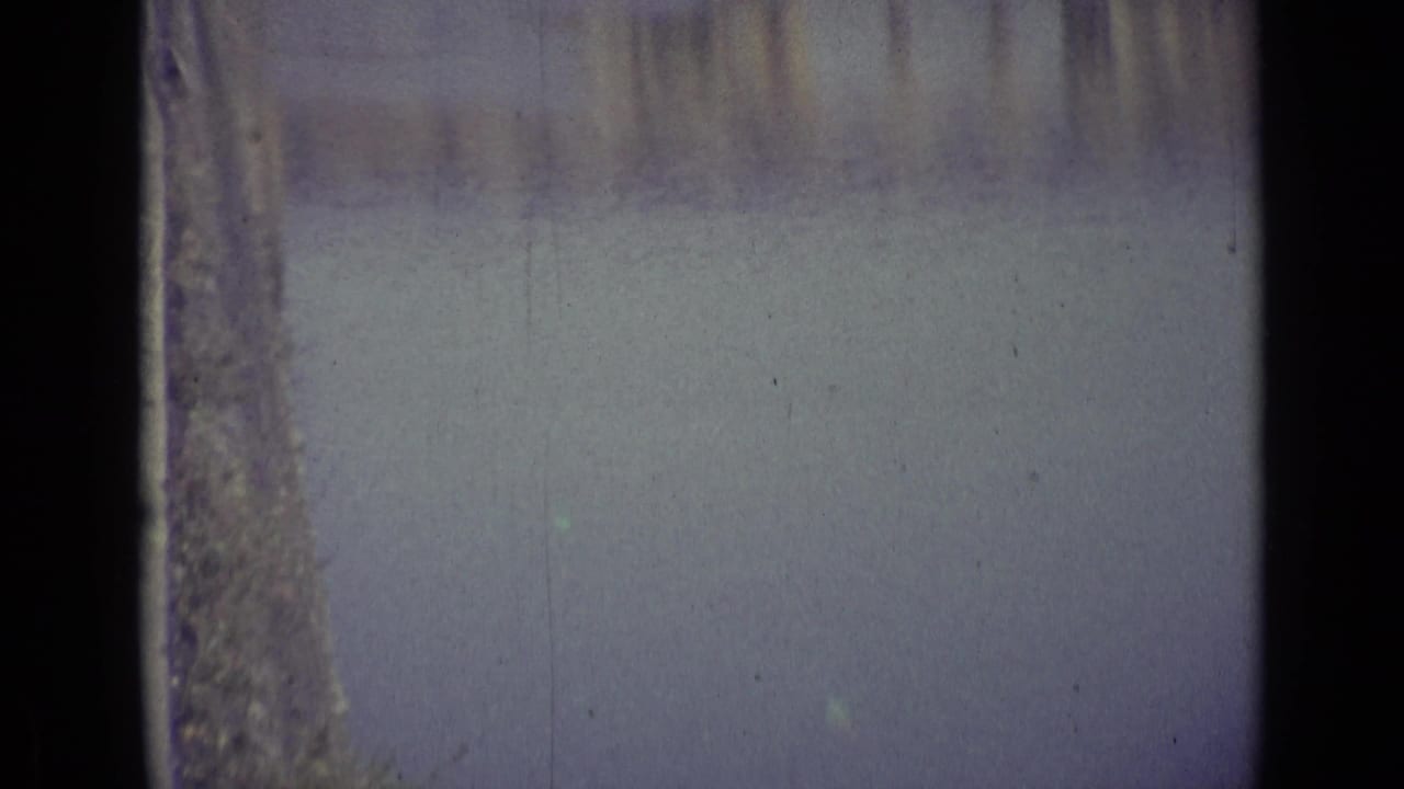 1962 8mm Florence footage begins with a soft, partially obscured view of water and faint riverside architecture.