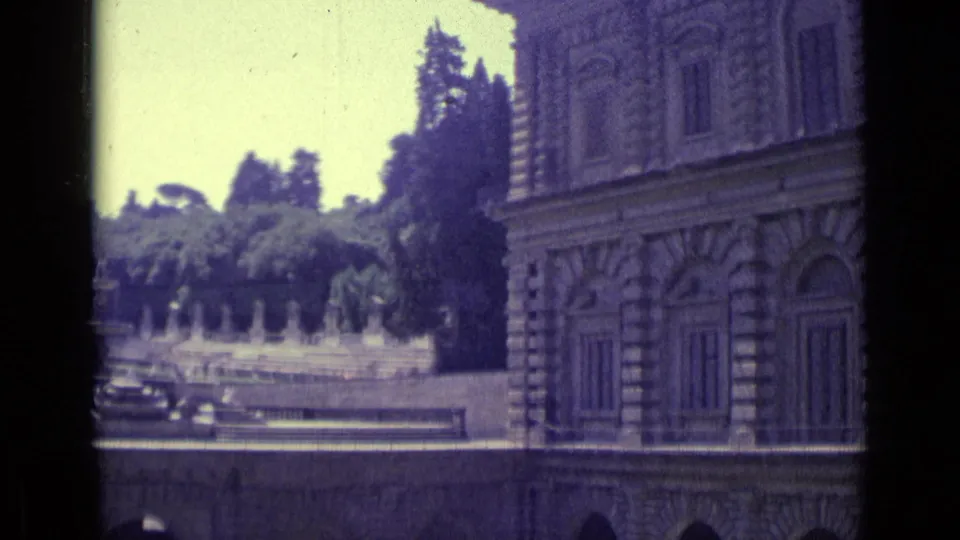 Florence 1962 home-movie view of a grand stone facade, fountain, statues, and formal garden planting.