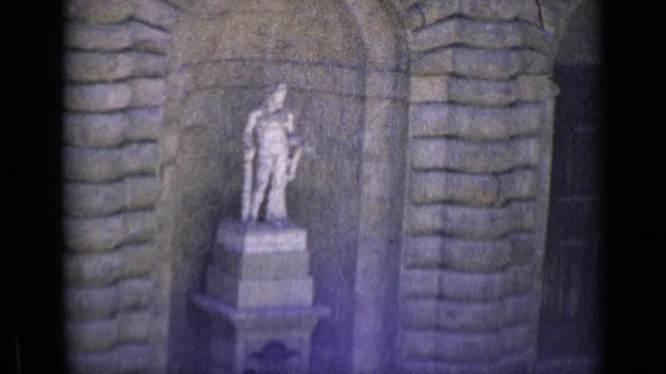 1962 Florence frame showing a standing stone figure on a pedestal within a masonry niche, with visible grain and bluish exposure shift.