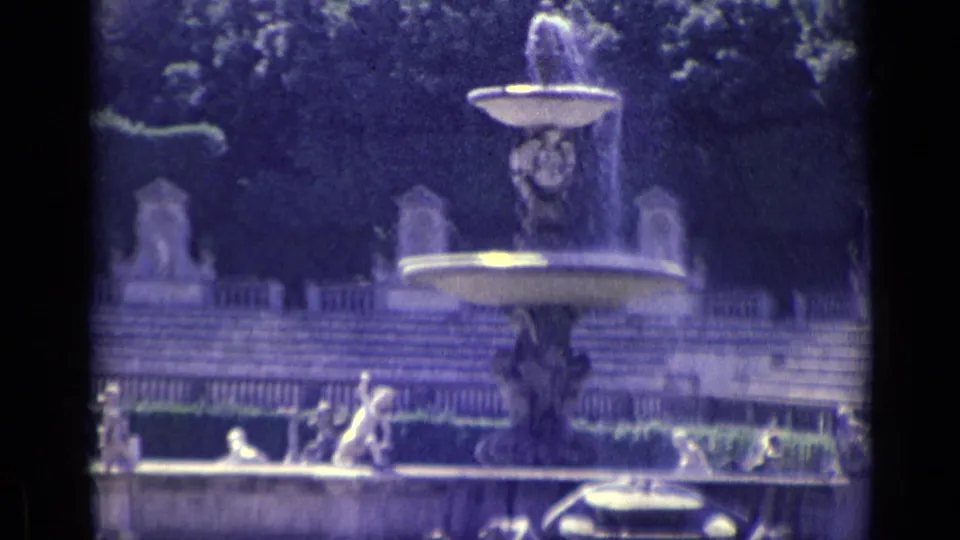 A closer 1962 Florence view of the fountain basin, sculptural figures, water jets, garden steps, and dark tree backdrop.
