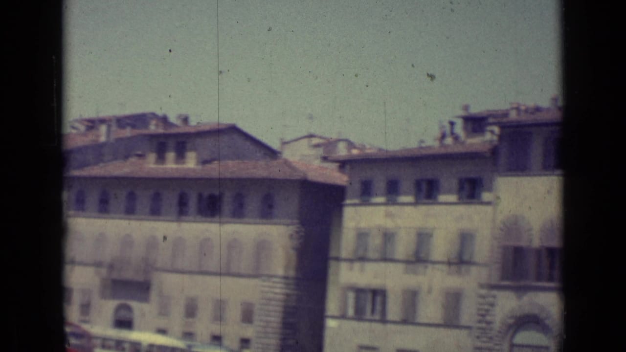 Historic building facades with arched windows and rooflines during the pan.