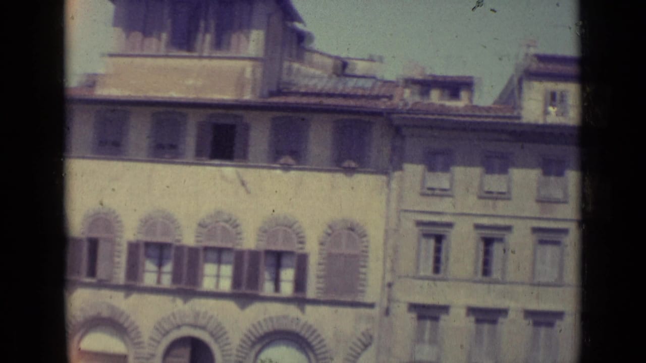 Florence building facades with shuttered windows, arched stonework, and tiled roofs.
