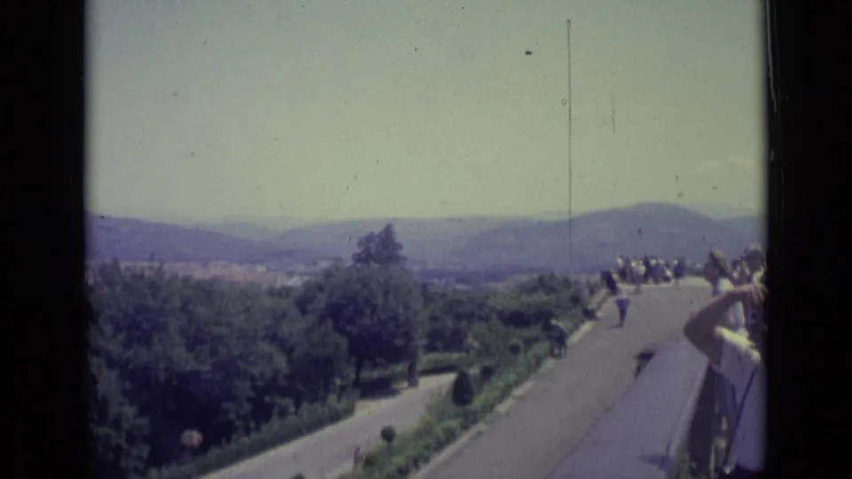 At a Florence scenic overlook in 1962, tourists gather near a railing while one person appears to raise a camera toward the view.