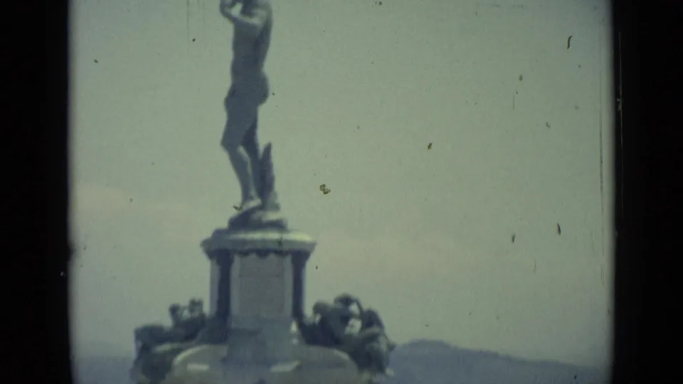 Florence travel footage shows a classical statue detail on a pedestal, filmed in soft faded 8mm color.