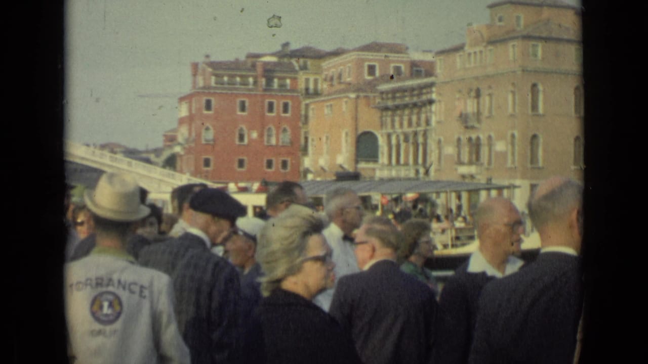 1962 Florence waterfront view with tourists gathered in the foreground and a visible Torrance Golf jacket among the crowd.