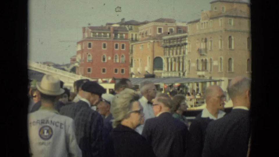 1962 Florence waterfront view with tourists gathered in the foreground and a visible Torrance Golf jacket among the crowd.