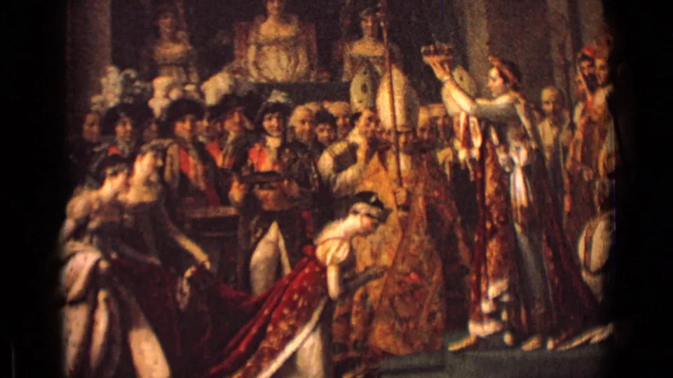 1962 Germany 8mm frame showing a painted or staged coronation scene with robed figures, onlookers, and a kneeling woman in red and white.