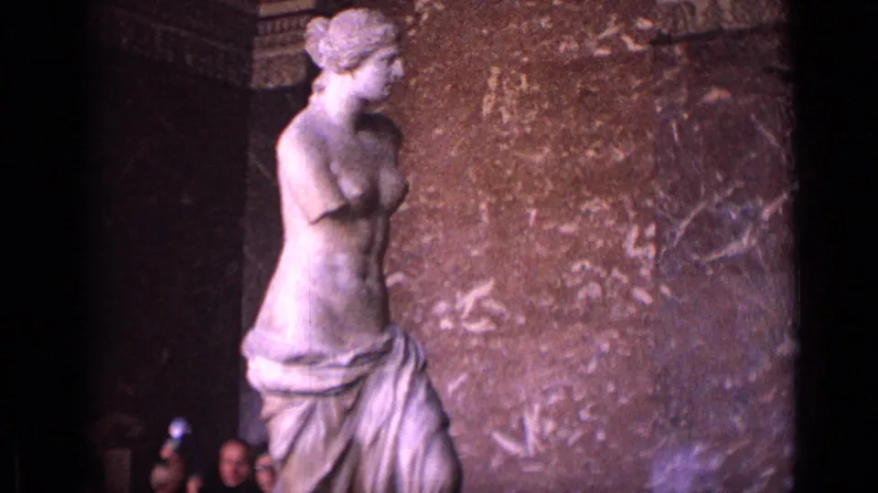 The statue fills the left side of the 1962 museum frame while several visitors appear partly cropped near the gallery floor.