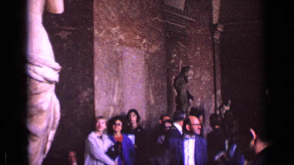 A large marble statue fills the left edge while 1962 Germany museum visitors cluster near the wall and smaller sculptures.