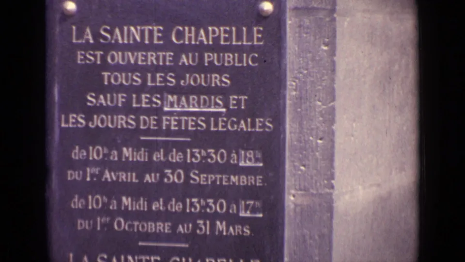 1960s 8mm frame cataloged as Germany showing a French Sainte Chapelle public-hours sign in close-up.