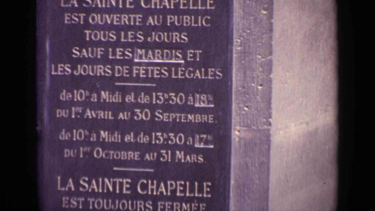 Close 8mm view of a French sign for La Sainte Chapelle, with public hours and closure details visible.