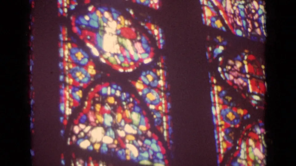 End frame of a 1962 Germany church window pan, showing bright stained-glass figure panels against a dark interior.
