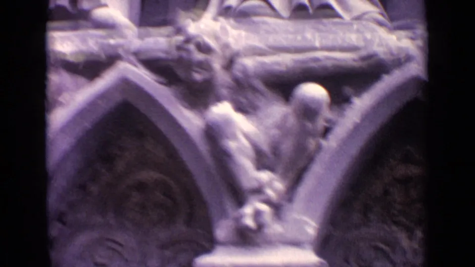 1962 Germany 8mm frame focused on Gothic-style pointed arches, gargoyle-like carvings, and weathered exterior stonework.