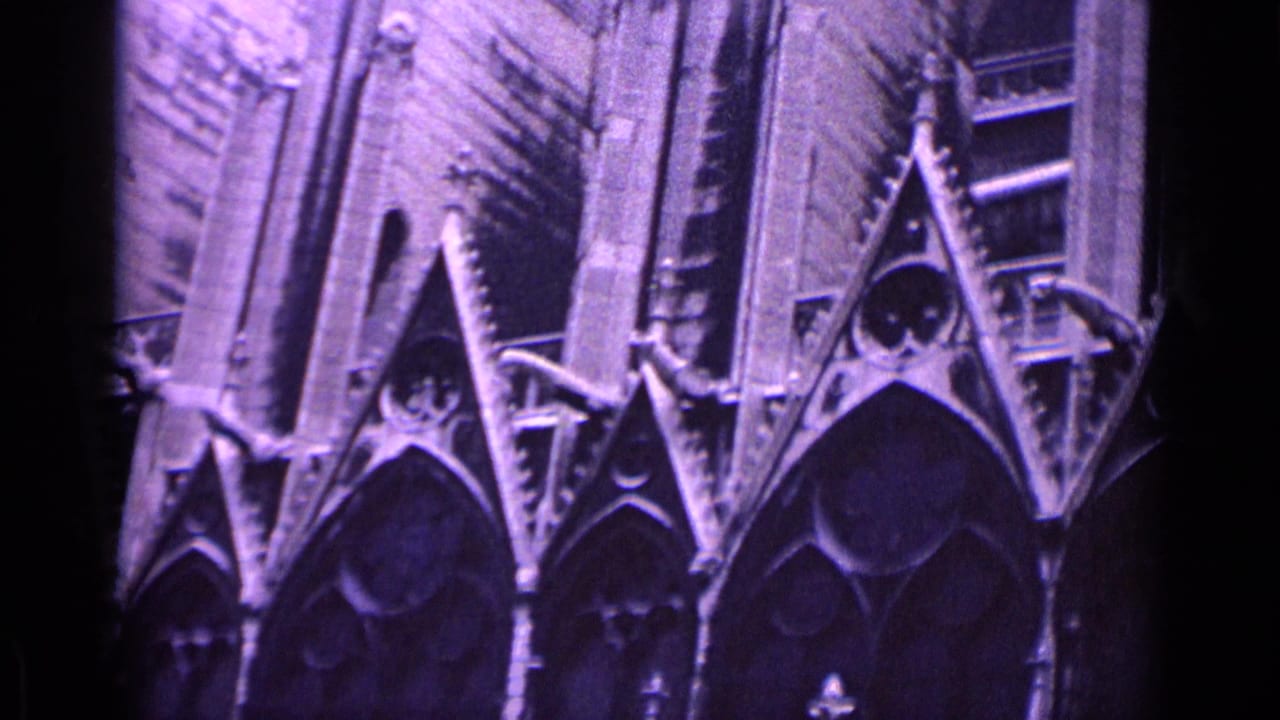 Closer view of cathedral stone gables, tracery, and tall wall sections.
