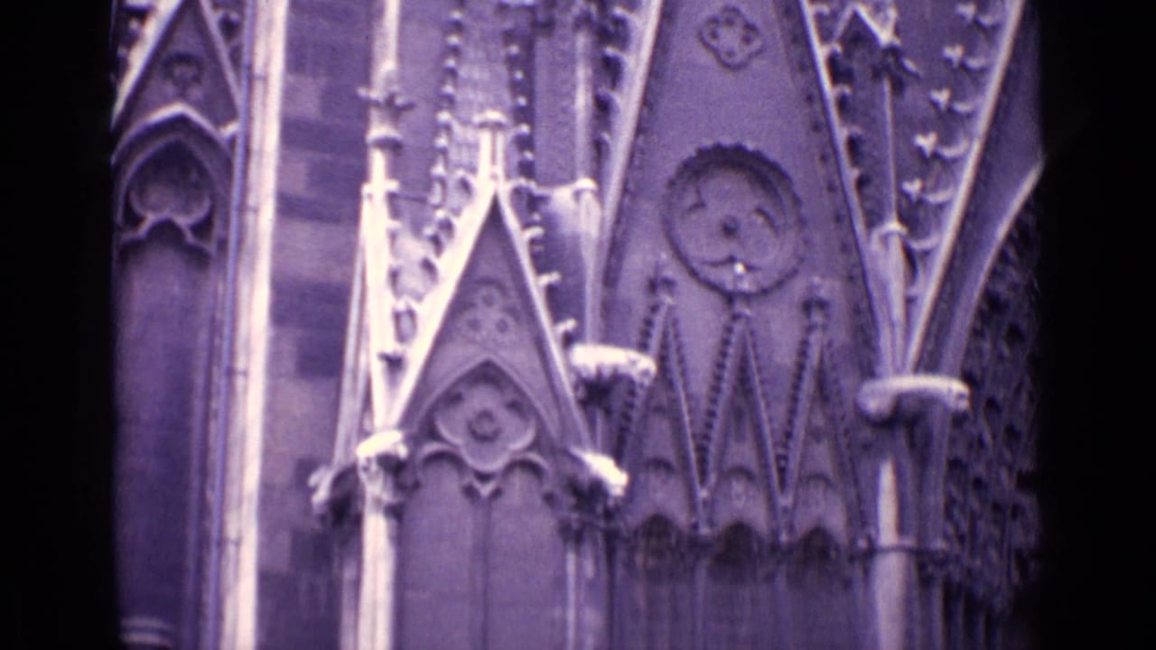 Close view of carved Gothic-style stonework with pointed arch details and columns.